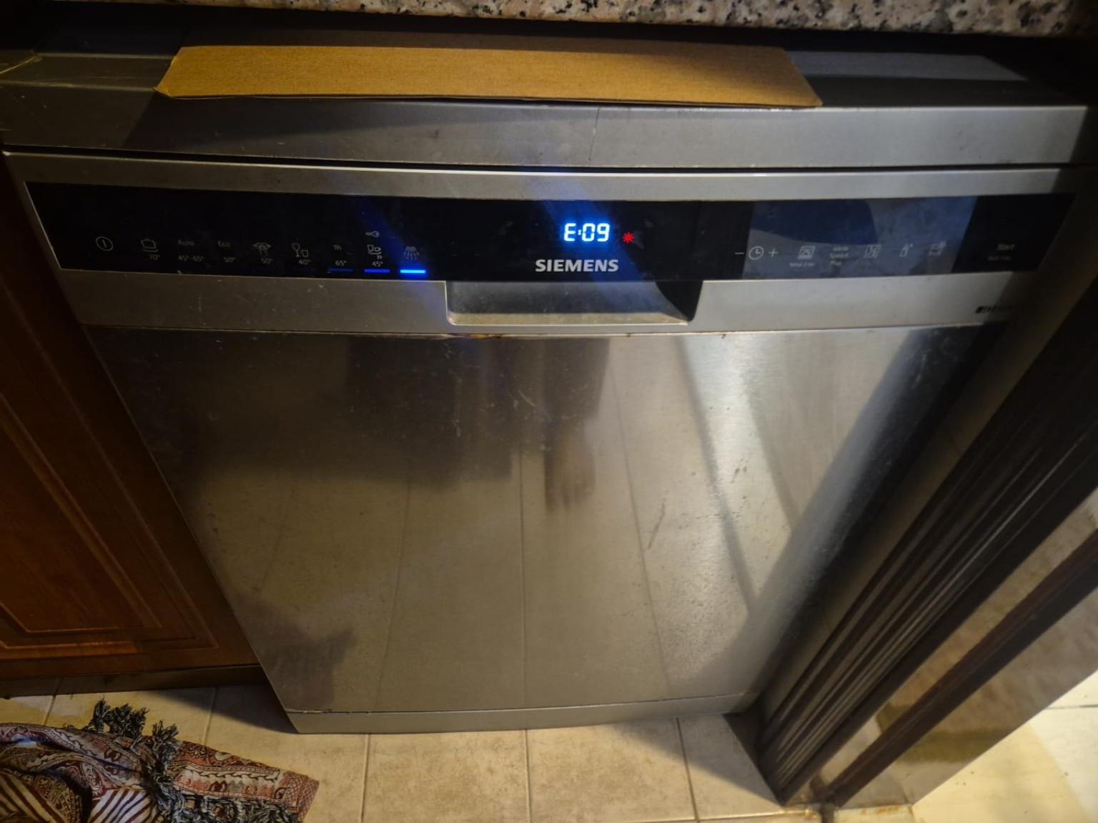Freestanding dishwasher showing an error code on its display, attended on a home visit in the UAE