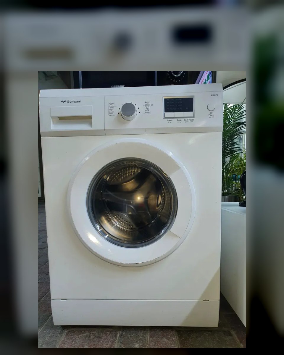 White front-load washing machine with a dial and digital control panel