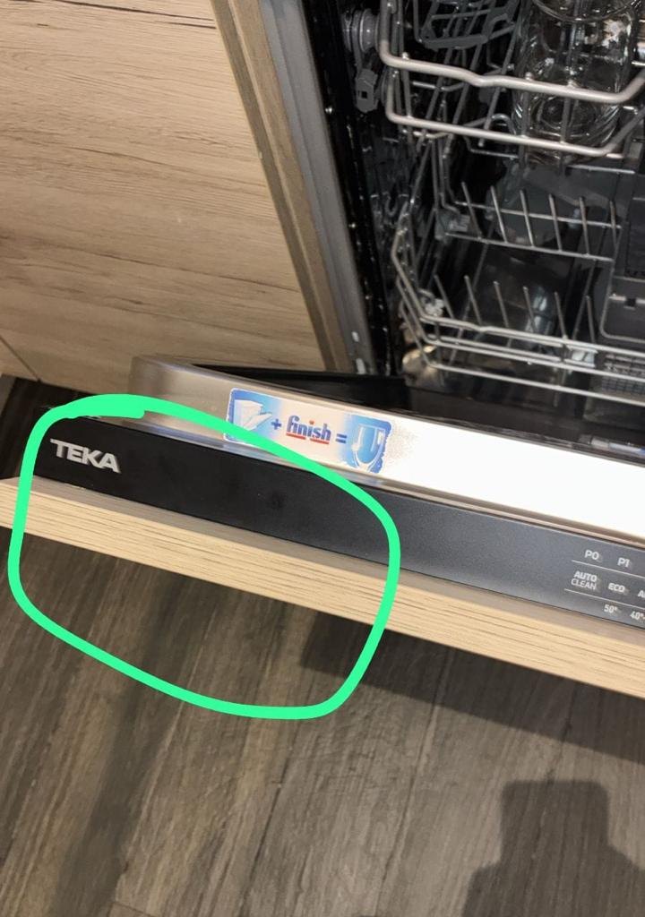 Door edge of an integrated dishwasher being inspected on a UAE service call