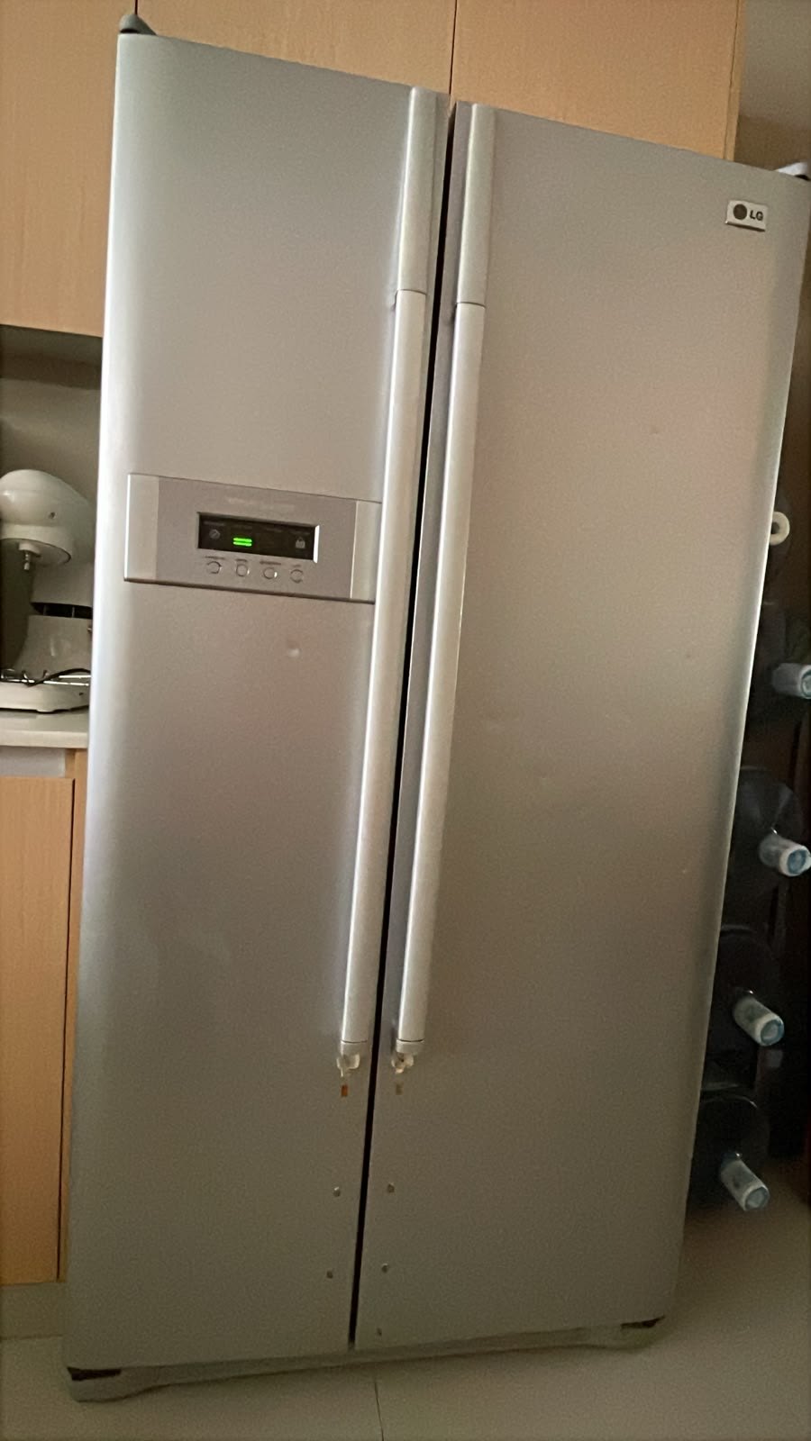 Side-by-side refrigerator with a door display panel attended in a UAE home